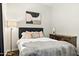 Comfortable bedroom with wood floors, lamps, decorative art, and stylish furniture at 14826 N 92Nd Pl, Scottsdale, AZ 85260