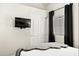 Cozy bedroom with TV, white closet doors, and window with blinds at 14826 N 92Nd Pl, Scottsdale, AZ 85260