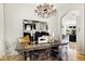 The dining room features a modern table, transparent chairs, and elegant chandelier at 14826 N 92Nd Pl, Scottsdale, AZ 85260