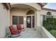 Inviting front porch with cozy seating, a decorative wreath, and a welcoming entrance to the home at 14826 N 92Nd Pl, Scottsdale, AZ 85260