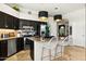 A modern kitchen boasts dark wood cabinets, stainless appliances, and a granite-topped island at 14826 N 92Nd Pl, Scottsdale, AZ 85260