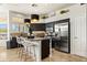 Modern kitchen with stainless steel appliances, granite countertops, and a stylish island with seating at 14826 N 92Nd Pl, Scottsdale, AZ 85260