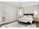 This main bedroom features a lovely chandelier, wood floors and access to the backyard through french doors at 14826 N 92Nd Pl, Scottsdale, AZ 85260
