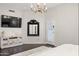 The main bedroom features hardwood floors, a large tv, and access to the outdoors at 14826 N 92Nd Pl, Scottsdale, AZ 85260