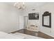 The main bedroom features hardwood floors, a chandelier, and a large tv at 14826 N 92Nd Pl, Scottsdale, AZ 85260