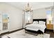Elegant main bedroom boasts a black headboard, hardwood floors, and french doors at 14826 N 92Nd Pl, Scottsdale, AZ 85260