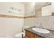 Bathroom featuring stone countertop, decorative tile, glass shelves and ample lighting at 151 E Broadway Rd # 103, Tempe, AZ 85282