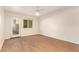 Light-filled bedroom featuring wood-look floors, neutral walls, ceiling fan, and access to outdoor views at 151 E Broadway Rd # 103, Tempe, AZ 85282