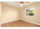 Bedroom featuring wood-look floors, a ceiling fan, and a window creating a calm atmosphere at 151 E Broadway Rd # 103, Tempe, AZ 85282