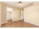 Bedroom with light-toned walls, wood-look floors, walk-in closet, and a ceiling fan for comfort at 151 E Broadway Rd # 103, Tempe, AZ 85282