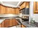 Updated kitchen with stainless steel appliances, granite countertops, and ample cabinet space at 151 E Broadway Rd # 103, Tempe, AZ 85282