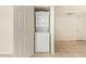 Convenient laundry closet with a stacked washer and dryer unit for efficient space-saving at 151 E Broadway Rd # 103, Tempe, AZ 85282