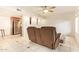 Open-concept living room with tile floors, neutral paint, and ceiling fan providing modern comfort and style at 151 E Broadway Rd # 103, Tempe, AZ 85282