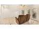 Well-lit living room featuring tile flooring, neutral paint, patio access, and a cozy seating area at 151 E Broadway Rd # 103, Tempe, AZ 85282