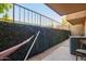 Tranquil patio view with hammock and ivy-covered wall providing a private retreat at 151 E Broadway Rd # 103, Tempe, AZ 85282