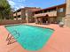 Community pool with lounge area in front of a multi story apartment building at 151 E Broadway Rd # 103, Tempe, AZ 85282