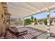 Charming backyard with a covered patio and lush landscaping at 16412 W Peppertree Ct, Surprise, AZ 85387