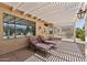 Relaxing backyard oasis with a covered patio and comfortable lounge chairs for enjoying the outdoors at 16412 W Peppertree Ct, Surprise, AZ 85387