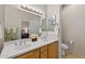Bathroom with double sinks, framed mirror, toilet, and bath towels creating a clean and refreshing space at 16412 W Peppertree Ct, Surprise, AZ 85387