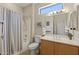 Bathroom featuring a shower/tub, toilet, large mirror, window, and neutral colors creating a peaceful retreat at 16412 W Peppertree Ct, Surprise, AZ 85387