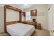Bedroom featuring a Murphy bed and built-in desk and cabinets for a functional living and workspace at 16412 W Peppertree Ct, Surprise, AZ 85387