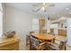 A dining room table surrounded by six chairs in a dining area with a ceiling fan at 16412 W Peppertree Ct, Surprise, AZ 85387