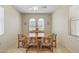 Traditional dining room with natural light, a wood table, and patterned chairs at 16412 W Peppertree Ct, Surprise, AZ 85387