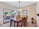 Dining room featuring a wood table, chandelier, and sliding glass doors to the patio at 16412 W Peppertree Ct, Surprise, AZ 85387