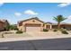 Single-story home featuring a two-car garage and low maintenance desert landscaping at 16412 W Peppertree Ct, Surprise, AZ 85387