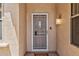 Close-up of the front door with a decorative security screen and a stylish overhead light fixture at 16412 W Peppertree Ct, Surprise, AZ 85387