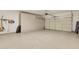Clean, spacious garage featuring epoxy floor coating and built-in storage cabinets at 16412 W Peppertree Ct, Surprise, AZ 85387