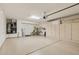Large garage with epoxy floor coating, storage cabinets, and a water heater at 16412 W Peppertree Ct, Surprise, AZ 85387