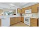 Bright kitchen featuring light wood cabinetry and white countertops at 16412 W Peppertree Ct, Surprise, AZ 85387