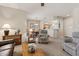 Open-concept living area provides seamless flow to the kitchen and dining area with a chair and wooden table at 16412 W Peppertree Ct, Surprise, AZ 85387