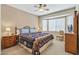 Bedroom with patterned quilt, bay window, side tables, and neutral walls at 16412 W Peppertree Ct, Surprise, AZ 85387
