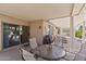 Inviting covered patio featuring a table, grill, and access to the home's interior at 16412 W Peppertree Ct, Surprise, AZ 85387