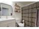 Bathroom with modern vanity, mirror, patterned shower curtain and stylish, neutral décor at 17032 N 16Th Dr # 8, Phoenix, AZ 85023