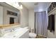 Bathroom with modern vanity, framed mirror and shower with a gray curtain and decorative wall art at 17032 N 16Th Dr # 8, Phoenix, AZ 85023