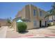 Two-story home with beige stucco, desert landscaping and privacy wall on a clear, blue-sky day at 17032 N 16Th Dr # 8, Phoenix, AZ 85023