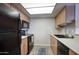 Efficient kitchen with black appliances, laminate countertops and cabinetry, and plenty of natural light at 17032 N 16Th Dr # 8, Phoenix, AZ 85023