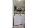 Cozy laundry area includes a washer, dryer, shelving with storage baskets and plenty of room for supplies at 17032 N 16Th Dr # 8, Phoenix, AZ 85023