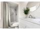 Bright bathroom featuring a shower, modern vanity with round mirror, and a marble countertop at 19031 N 13Th Dr, Phoenix, AZ 85027