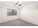 Neutral bedroom with a carpeted floor, ceiling fan and a window with exterior views at 19031 N 13Th Dr, Phoenix, AZ 85027