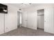 Neutral bedroom with a closet and views into another room, carpet flooring, and modern ceiling fan at 19031 N 13Th Dr, Phoenix, AZ 85027