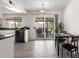 Bright dining area with an updated light fixture and sliding doors to the covered patio at 19031 N 13Th Dr, Phoenix, AZ 85027