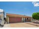 Inviting single-story home with an attached garage, xeriscaped yard, and shaded front porch at 19031 N 13Th Dr, Phoenix, AZ 85027