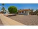 Charming home featuring a xeriscaped front yard, mature tree, and neutral color palette at 19031 N 13Th Dr, Phoenix, AZ 85027
