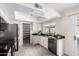 Bright kitchen with stainless steel appliances, white cabinets, and black countertops, featuring a pantry at 19031 N 13Th Dr, Phoenix, AZ 85027