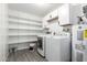 The Laundry Room features shelving, cabinets, washer, and dryer at 19031 N 13Th Dr, Phoenix, AZ 85027