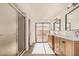 This bathroom features a shower, toilet, dual sink, and a sliding glass door at 1955 Leisure World --, Mesa, AZ 85206